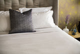 Bed made with Thomaston Mills American Boutique Sheets and a grey throw pillow