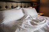 Bed made with Thomaston Mills T-250 Satin Stripe Sheets and Pillowcases.