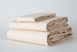 Thomaston T-200 Bone Pilllowcases and sheets folded and stacked. 