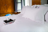 Bed made with Thomaston Mills T-310 Satin Stripe Sheets and Pillowcases.