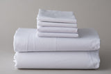 Thomaston T-200 Pillowcases and sheets folded and stacked.