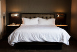 Bed made with Thomaston Mills T-250 Satin Stripe Sheets and Pillowcases.