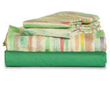 Thomaston Healthcare Green and Stiped Sheets and Pillowcases folded and stacked.